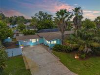 Aerial view of teal house with palm trees at 119 Hardin Pl, Edgewater, FL 32132