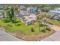 Aerial view of beach house with pool, and surrounding neighborhood at 327 Due East St, New Smyrna Beach, FL 32169