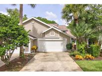 Two-story townhouse with a double-car garage and landscaped yard at 2051 Cornell Pl, Port Orange, FL 32128