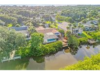 Aerial view of canal front property with private dock and pool at 40 Oak Tree Dr, New Smyrna Beach, FL 32169