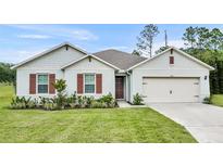 Two-story home with attractive front yard landscaping at 350 Sunset Point Dr, Ormond Beach, FL 32174