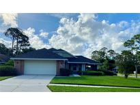 Single story home with attached garage and well maintained lawn at 101 Braeburn Cir, Daytona Beach, FL 32114