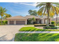 Two-story home with three car garage and landscaped yard at 728 Sea Duck Dr, Daytona Beach, FL 32119