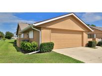 Attached garage with driveway and landscaping at 11 Andrea Dr, New Smyrna Beach, FL 32168