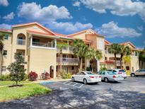 Two-story condo building with red tile roofs, balconies and plenty of parking at 460 Bouchelle Dr # 101, New Smyrna Beach, FL 32169