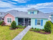 Charming two-toned cottage with screened porch at 456 Lime Ave, Daytona Beach, FL 32124