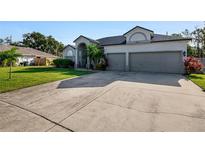 Two-story house with a three-car garage and well-maintained lawn at 510 Sun Lake Dr, Port Orange, FL 32127