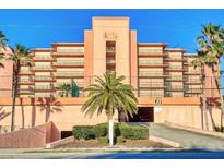 Multi-story building with parking garage and tropical landscaping at 4141 S Atlantic Ave # 502, New Smyrna Beach, FL 32169