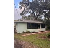 Charming light green house with a screened porch at 1921 Jungle Rd, New Smyrna Beach, FL 32168