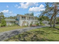 Two-story house with green roof and white siding at 2905 Turnbull Bay Road, New Smyrna Beach, FL 32168