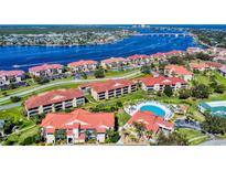 Aerial view of waterfront community with pool and lush landscaping at 452 Bouchelle Dr # 303, New Smyrna Beach, FL 32169