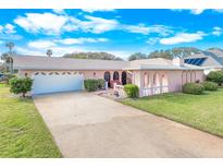Single-story home with attached garage and landscaping at 110 Ponce Terrace Cir, Ponce Inlet, FL 32127