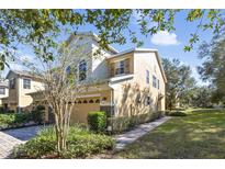 Two-story house with a paved driveway, landscaping, and a two-car garage at 2681 Sweet Magnolia Pl, Oviedo, FL 32765