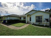 House exterior showcasing a well-maintained lawn and landscaping at 3218 Royal Palm Dr, Edgewater, FL 32141