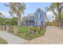 Two-story home with a landscaped yard and gated driveway at 532 Faulkner St, New Smyrna Beach, FL 32168