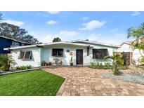 Charming mid-century home with landscaped yard and brick driveway at 624 S Pine St, New Smyrna Beach, FL 32169