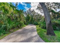 Brick walkway winding through lush landscaping at 6263 Palomino Cir, Port Orange, FL 32127