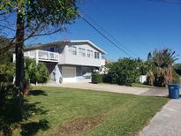 Two-story house with attached garage and a spacious yard at 824 Garfish Ave, New Smyrna Beach, FL 32169