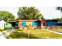 Cute bungalow style home with a painted exterior, turquoise shutters and a large yard at 131 W Palm Way, Edgewater, FL 32132