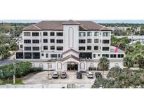 Three-story building with parking and landscaping at 200 S Riverside Dr # 2010, New Smyrna Beach, FL 32168