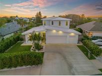 Aerial view of a modern house with a large driveway and landscaped yard at 2022 N Peninsula Ave, New Smyrna Beach, FL 32169
