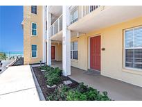 Exterior view of condo building showcasing landscaping and ocean views at 3801 S Atlantic Ave # Ut104, New Smyrna Beach, FL 32169