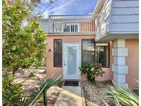 Inviting condo exterior with lush landscaping and private entrance at 4150 S Atlantic Ave # 103A, New Smyrna Beach, FL 32169