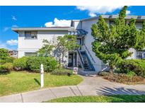 Condo building exterior showcasing entrance and landscaping at 4411 Sea Mist Ct # 275, New Smyrna Beach, FL 32169