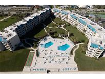 Aerial view of condo community with pool, shuffleboard, and oceanfront location at 4501 S Atlantic Ave # 4170, New Smyrna Beach, FL 32169