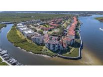 Aerial view of waterfront community with lush landscaping and boat slips at 460 Bouchelle Dr # 305, New Smyrna Beach, FL 32169