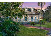 Two-story house with blue shutters, a porch, and a brick walkway at 535 Valley Stream Dr, Geneva, FL 32732