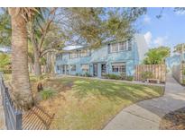 Light blue two-story building with a well-maintained lawn and walkway at 101 N Pine St # 7, New Smyrna Beach, FL 32169