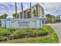 Oceanwalk Condominiums sign with lush landscaping and building exterior at 5300 S Atlantic Ave # 9-304, New Smyrna Beach, FL 32169
