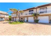 Charming two-story home with balconies, attached garages, and palm trees in the front yard at 731 Laurel Bay Cir, New Smyrna Beach, FL 32169