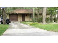 House exterior with driveway and landscaping at 1108 N Hart Blvd, Orlando, FL 32818
