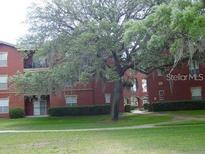 Brick apartment building with landscaping and ample parking at 1321 Arbor Vista Loop # 209, Lake Mary, FL 32746