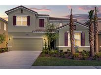 Two story home with neutral exterior and landscaping at 5288 Oakbourne Ave, Davenport, FL 33837