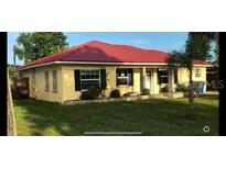 Single-story home with red roof and mature landscaping at 910 Lake Ave, Edgewater, FL 32132