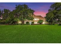 Stunning two-story home with manicured lawn and mature trees at 10980 Jim Edwards Rd, Haines City, FL 33844