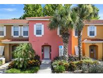 Two-story townhouse with a coral exterior at 8407 Blue Lagoon Dr, Kissimmee, FL 34747
