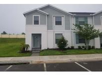 Two-story townhome with light gray siding at 2452 Dubai St, Kissimmee, FL 34747