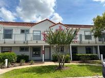Two-story building with multiple units and landscaping at 2512 Woodgate Blvd # 104, Orlando, FL 32822