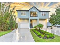 Two-story house with a two-car garage and landscaped front yard at 2794 Nordman Ave, New Smyrna Beach, FL 32168