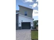 Modern two-story home with attached garage at 8879 Cabot Cliffs Dr # 102, Davenport, FL 33896