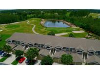 Community overview featuring golf course and pond views at 9447 Myrtle Creek Ln # 112, Orlando, FL 32832