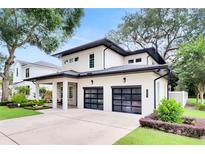 Two-story modern home with two-car garage and landscaped yard at 1871 Taylor Ave, Winter Park, FL 32789