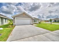 One-story house with a garage and landscaping at 1278 Tagliamento Ln, Haines City, FL 33844
