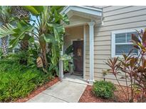 Townhouse exterior with landscaped walkway and lush greenery at 2958 Lucayan Harbour Cir # 108, Kissimmee, FL 34746