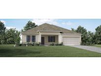 One-story home with a light beige exterior and landscaping at 2231 Elegant Manor Cir, Edgewater, FL 32141