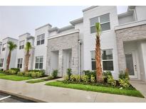 Modern townhouses with stone accents and landscaping at 17428 Hidden Forest Dr, Clermont, FL 34714